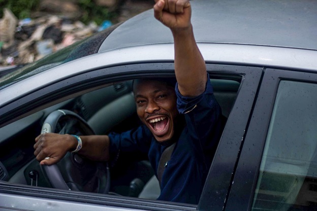 A picture of a happy man driving his car after getting help from CarGuard Administration.
